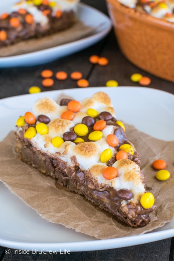 Reese's S'mores Cookie Pizza recipe - layers of cookie, marshmallow, and 3 kinds of Reese's make this a must make dessert for peanut butter lover's.