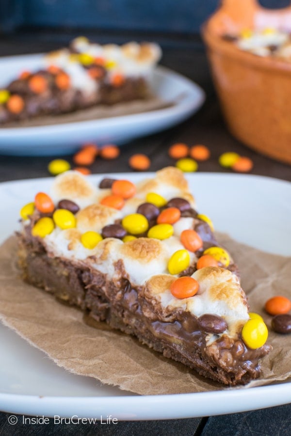 Layers of cookie, marshmallow, and 3 kinds of Reese's make this Reese's S'mores Cookie Pizza disappear in a hurry! Easy dessert recipe.