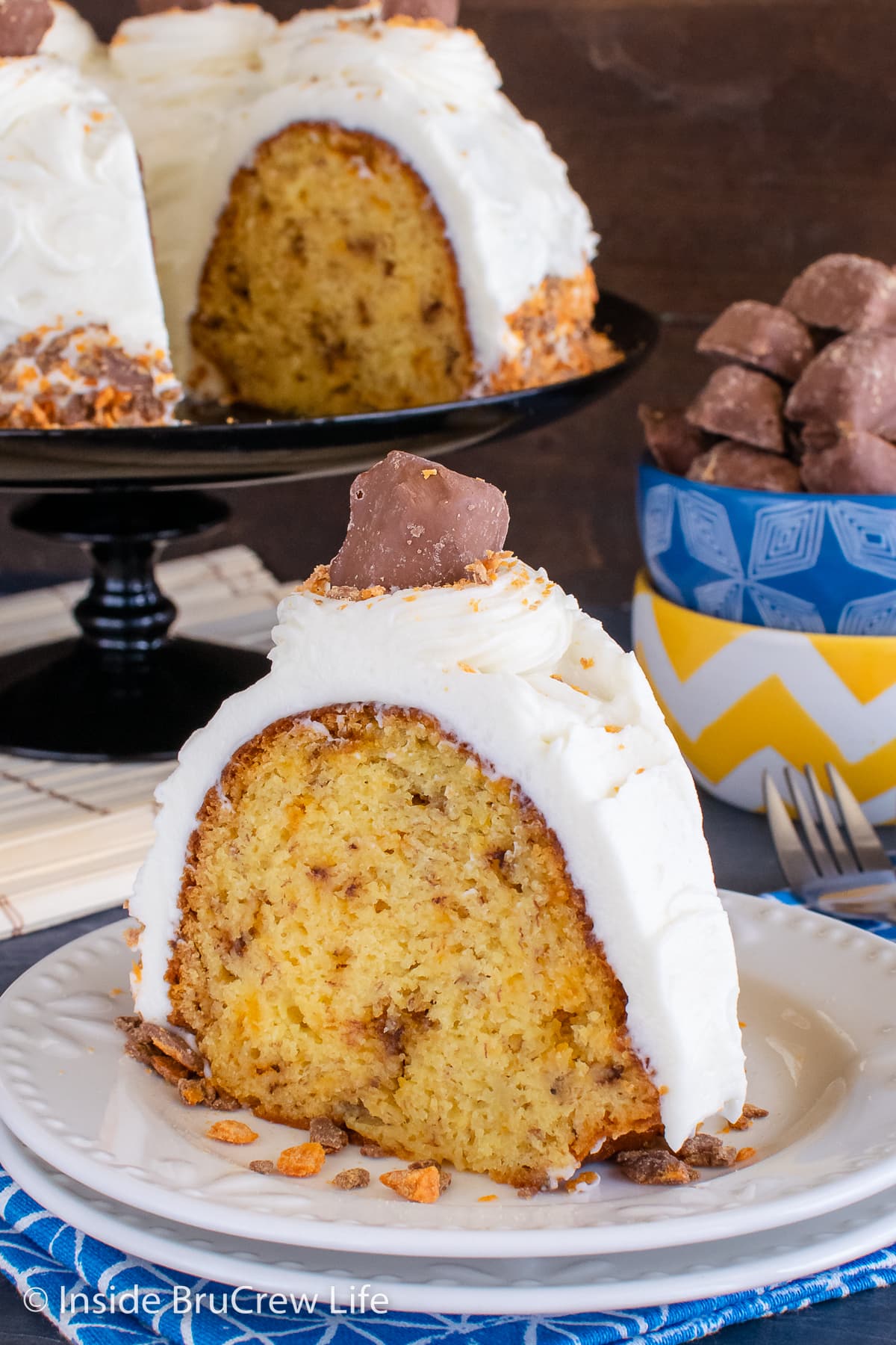 A white plate with a slice of banana cake on it.