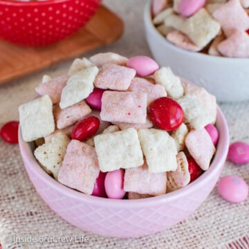 A pink bowl filled with strawberry muddy buddies and Valentine's M&M's.