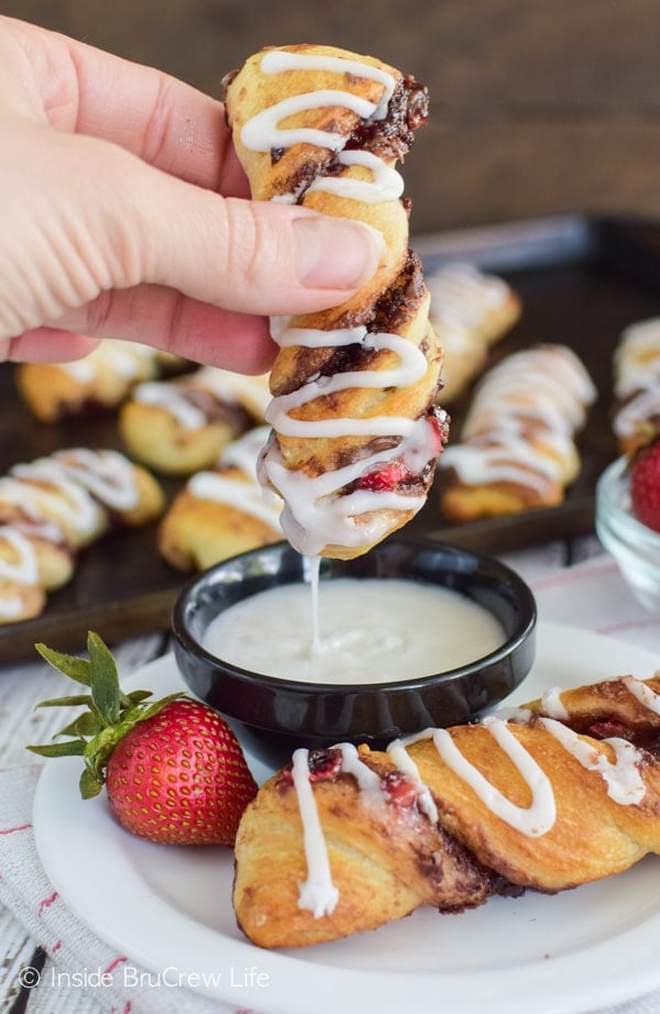 Dunking these Strawberry Nutella Twists in a sugar glaze is so fun and delicious! Great breakfast or snack recipe!