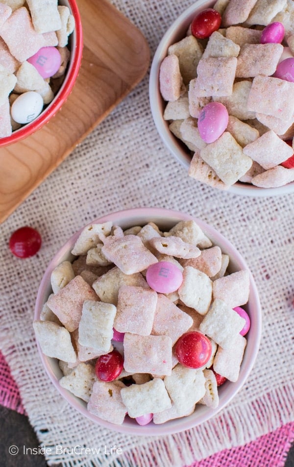 This fun Strawberry Shortcake Muddy Buddies has cookie crumbs and strawberry cake mix coating it. Perfect dessert recipe for Valentine's day or summer picnics.