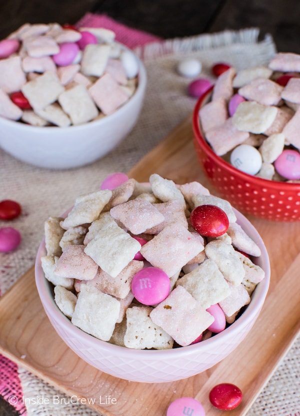 Adding strawberry cake mix and shortbread cookie crumbs makes this Strawberry Shortcake Muddy Buddies disappear in a hurry. It's the perfect no bake recipe for Valentine's day or summer picnics.