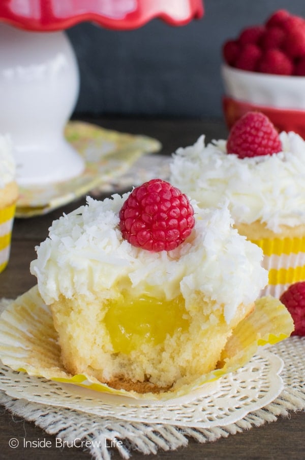 A close up picture of the center of the Lemon Coconut Cupcakes topped with a fresh raspberry