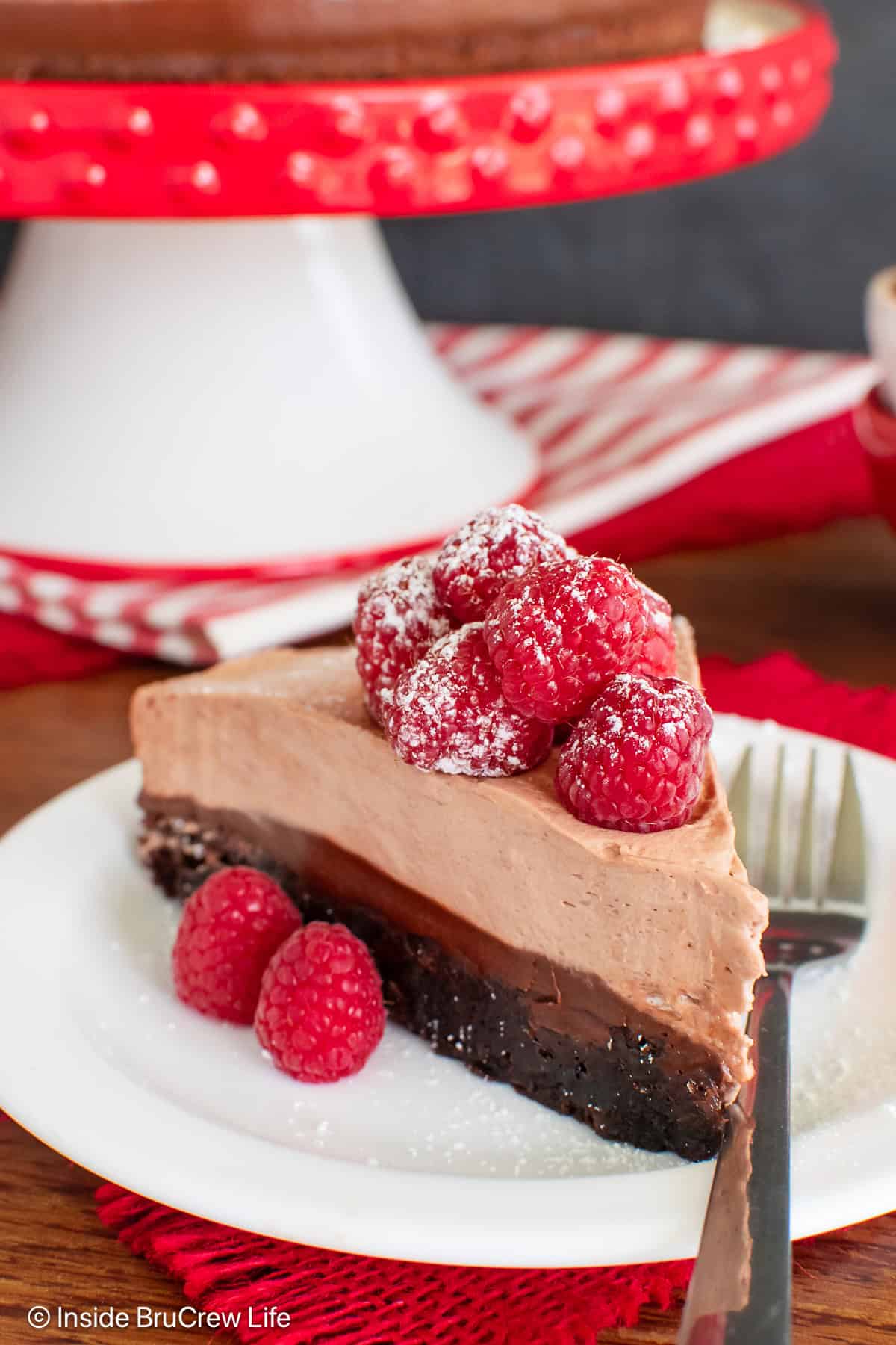 A slice of Nutella brownie cake on a white plate.