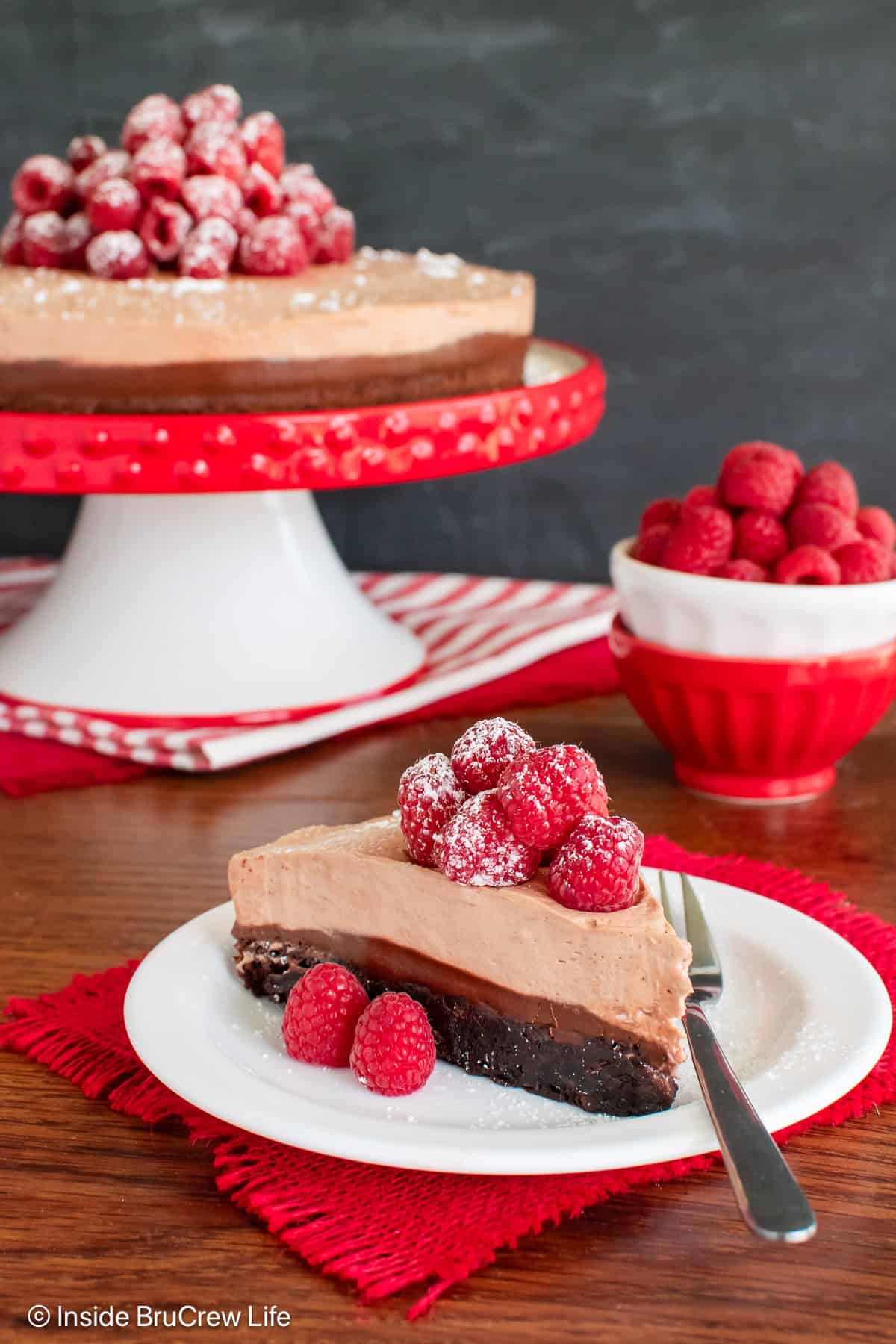 A slice of Nutella brownie mousse cake on a white plate.