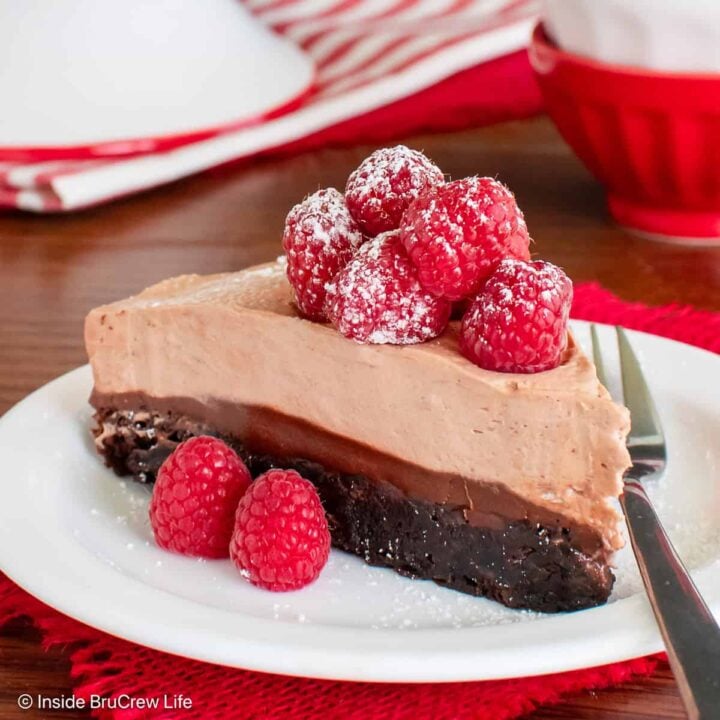 A white plate with a slice of layered Nutella brownie cake.