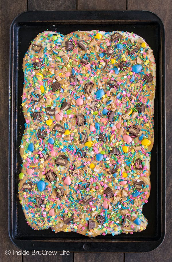 A cookie tray full of peanut butter and chocolate bark loaded with Easter sprinkles.