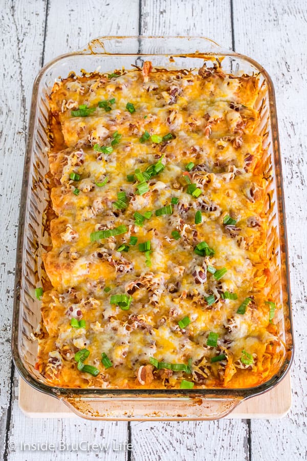 A top shot of a pan of Monterey Chicken Enchiladas topped with green onions