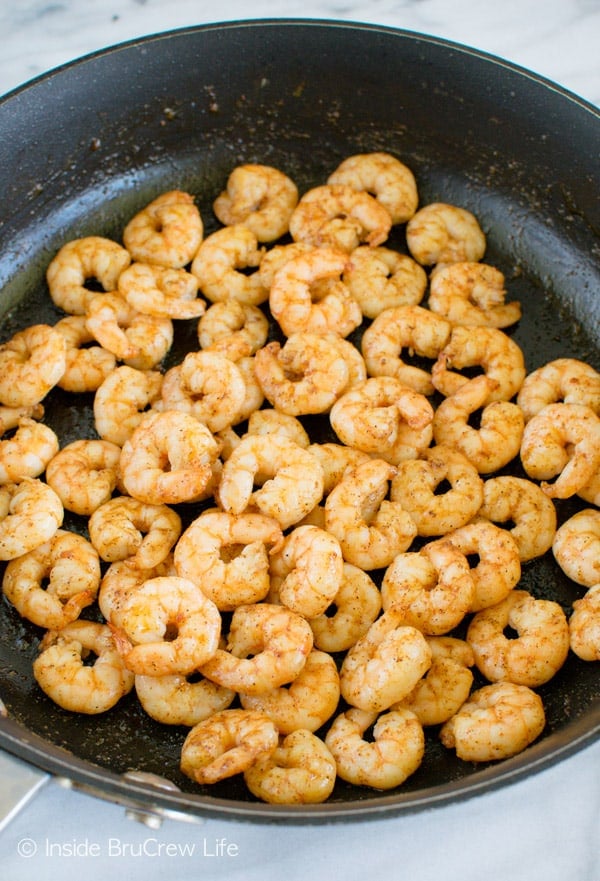 A close up of a black pan filled with Caribbean Jerk Shrimp Tacos