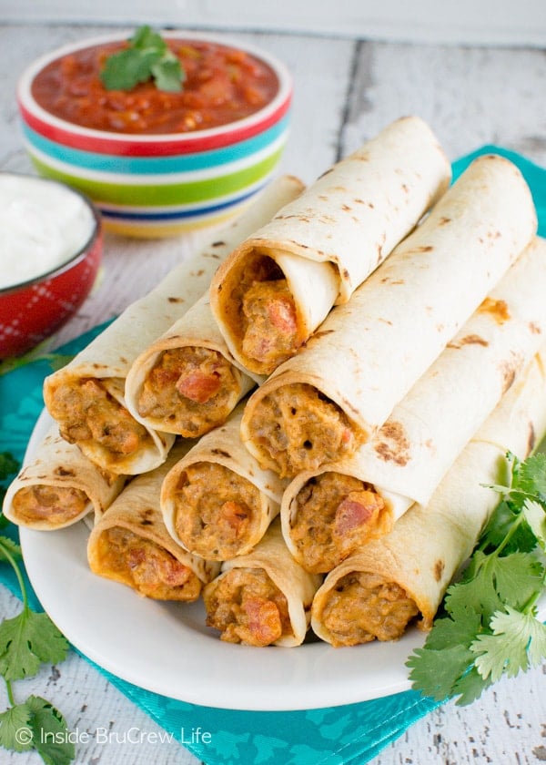A plate full of ground beef and cheese wrapped in tortillas.