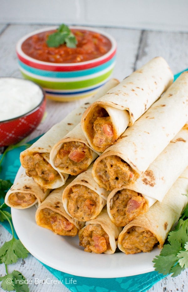 A cheesy beef mixture stuffed into tortillas on a white plate.