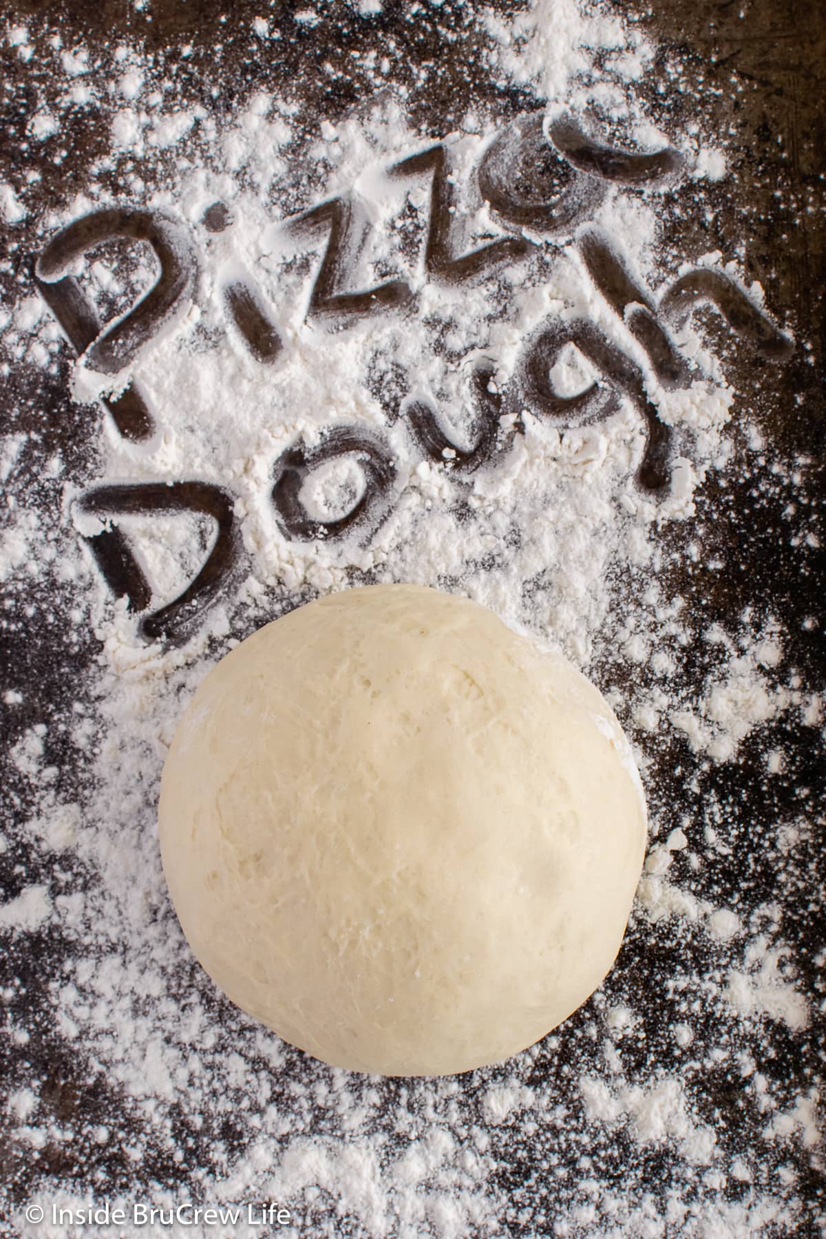 A dough ball on a floured surface.