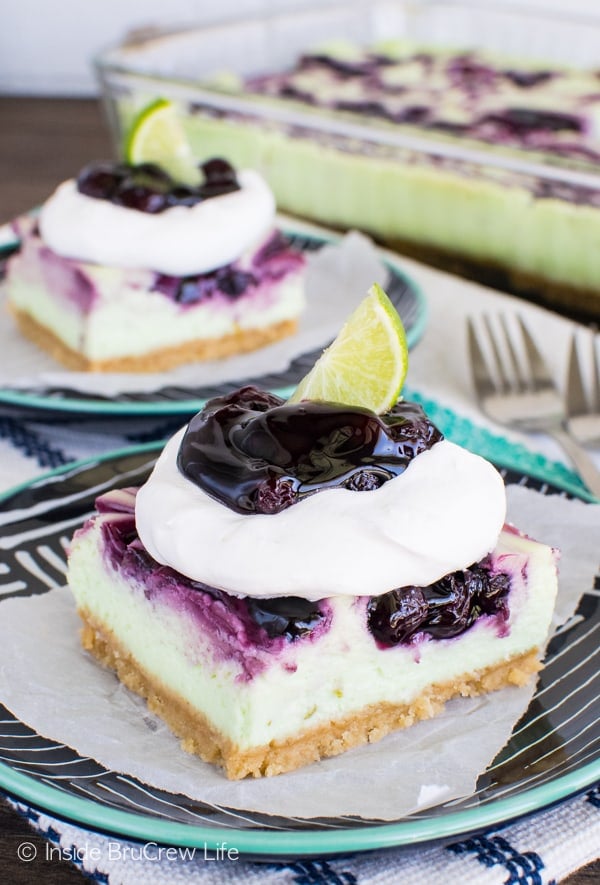 Blueberry Key Lime Cheesecake Squares - the creamy citrus cheesecake with blueberry swirls is a pretty summer dessert. Make this easy recipe for parties and picnics. #cheesecake #blueberry #piefilling #cheesecakebars #keylime #summerdesserts