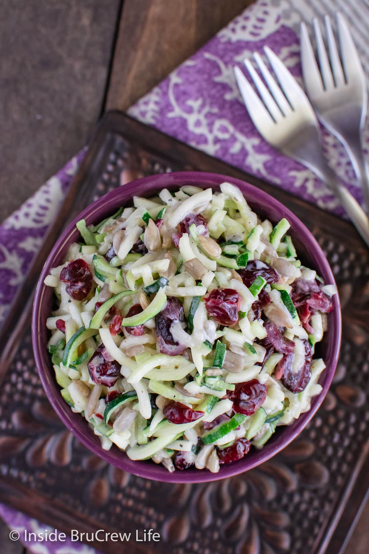 Overhead picture of a purple bowl filled with zucchini slaw.