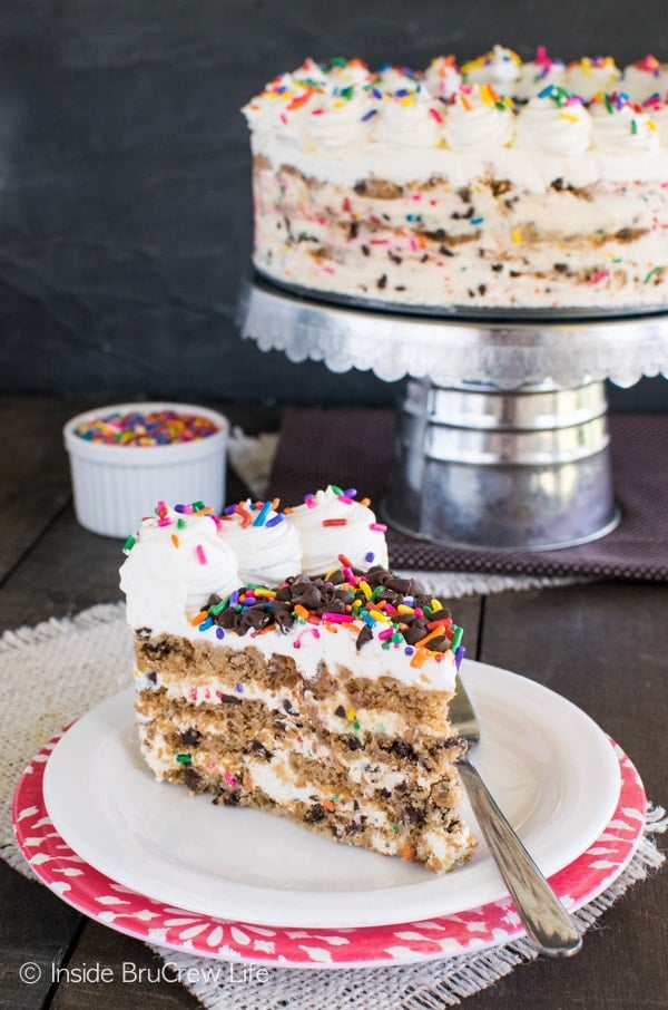 A slice of cookie cake on a white plate.