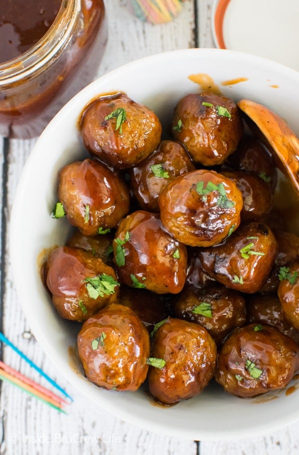 An overhead picture of a white bowl filled with honey sriracha barbecue meatballs