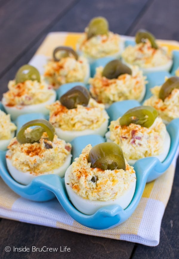 A blue tray full of bacon, jalapeño deviled eggs.