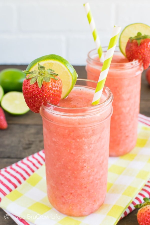 Berries, juice, and ice get blended together to make these easy Strawberry Limeade Slushies! Perfect drink recipe for a hot summer day!