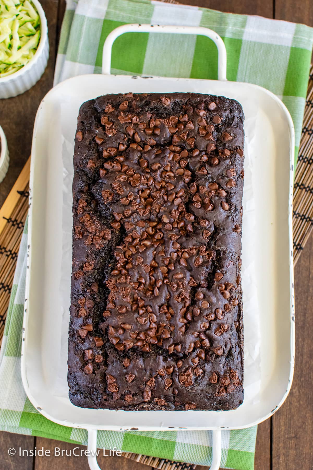 A baked chocolate bread topped with chocolate chips.