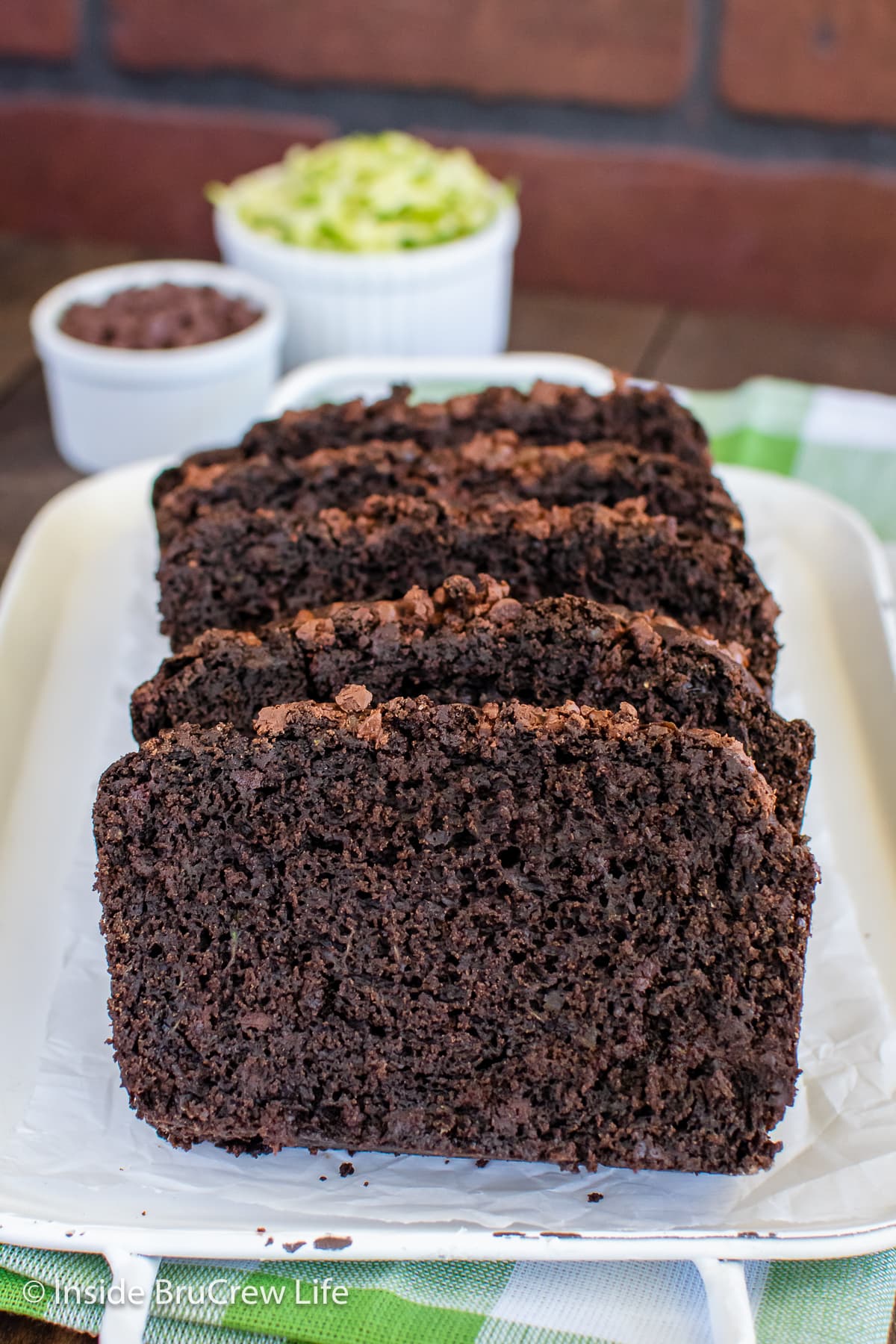 Slices of chocolate bread on a white tray.