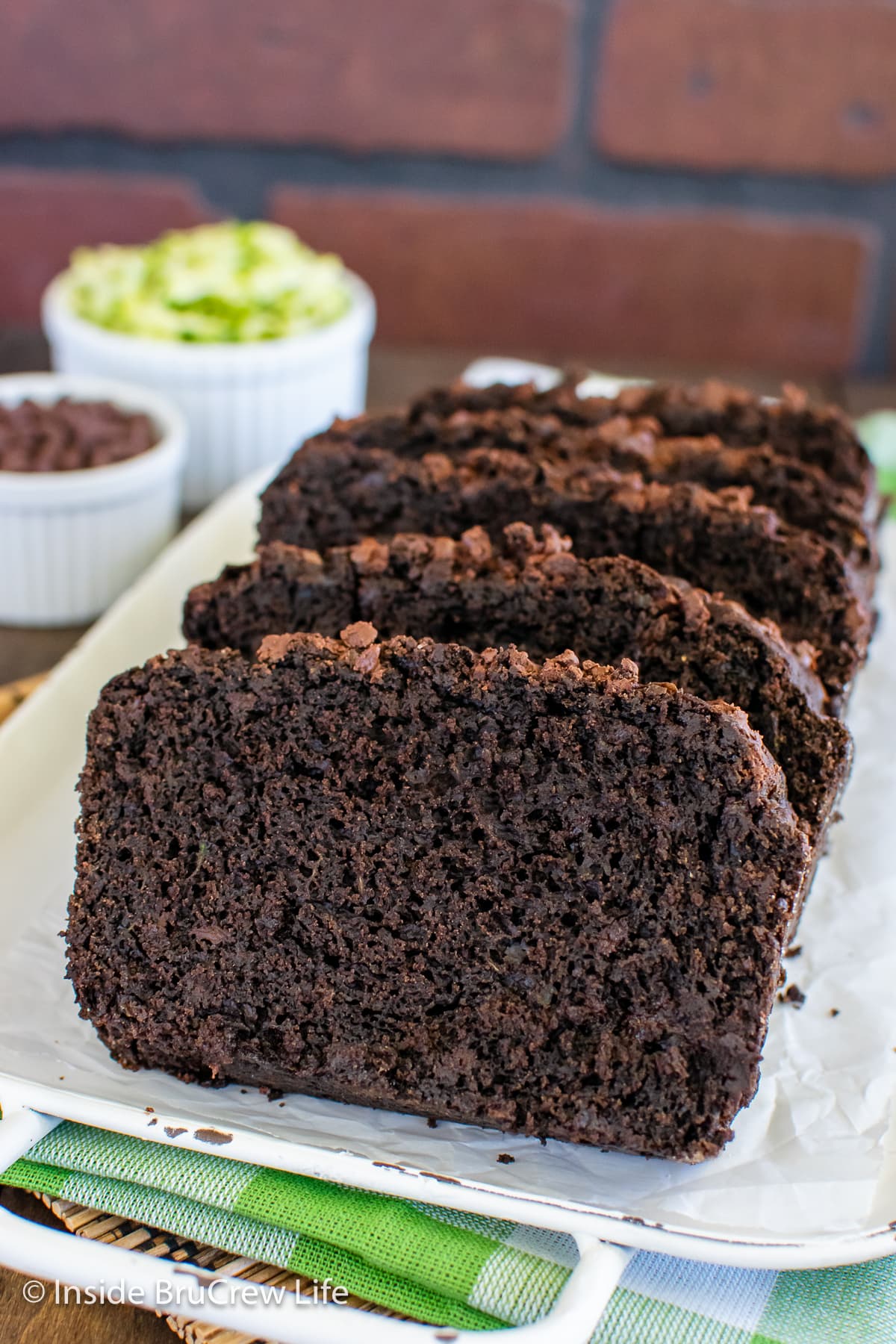 Chocolate sweet bread slices on a white tray.