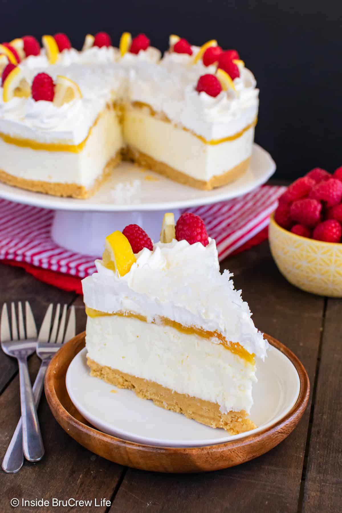 A slice of no bake lemon coconut cheesecake on a plate with the rest behind it.