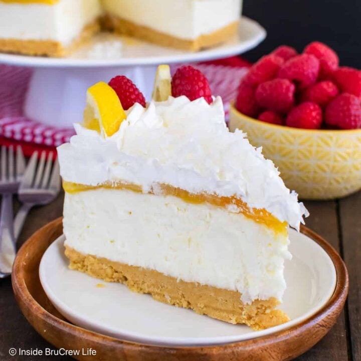 A slice of no bake lemon coconut cheesecake on a plate with the rest behind it.