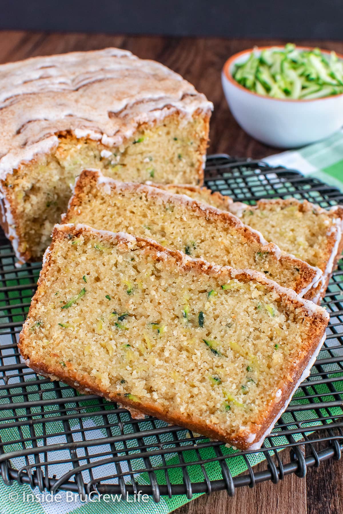 Slices of tropical zucchini bread on a wire rack.