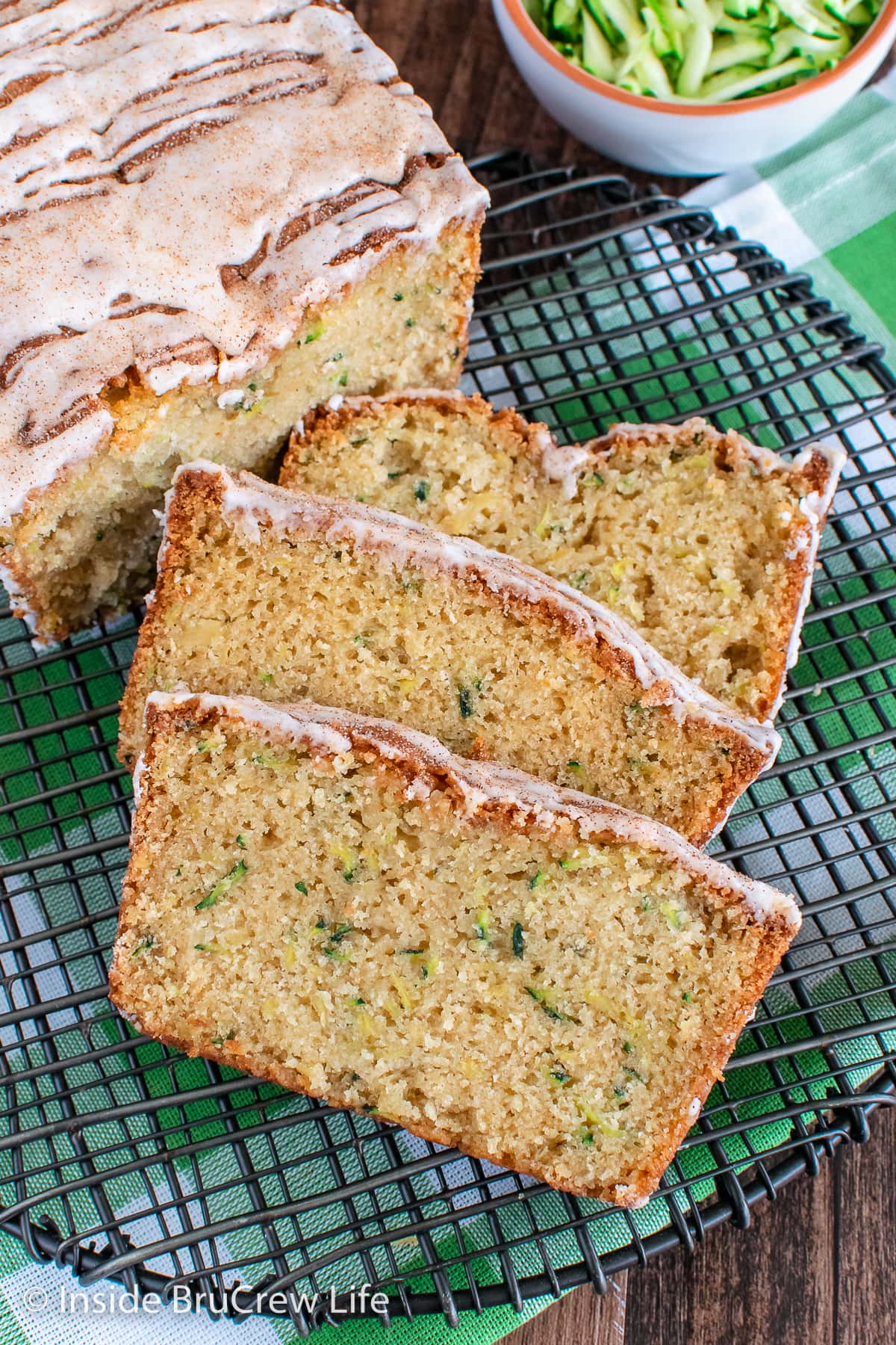 Slices of tropical zucchini bread on a wire rack.