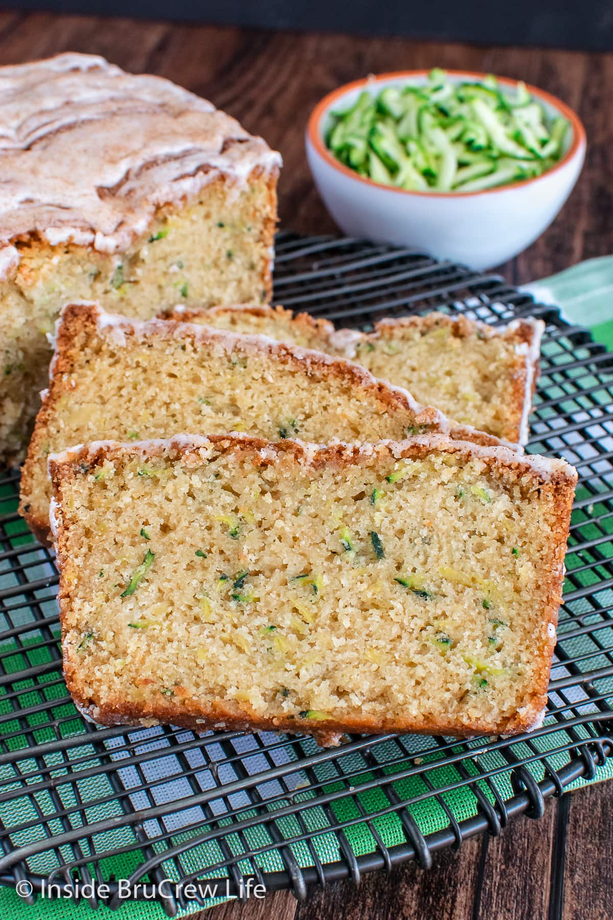 Slices of tropical zucchini bread on a wire rack.