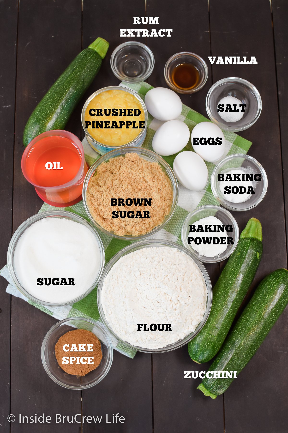 A dark board with bowls of ingredients to make a sweet bread.