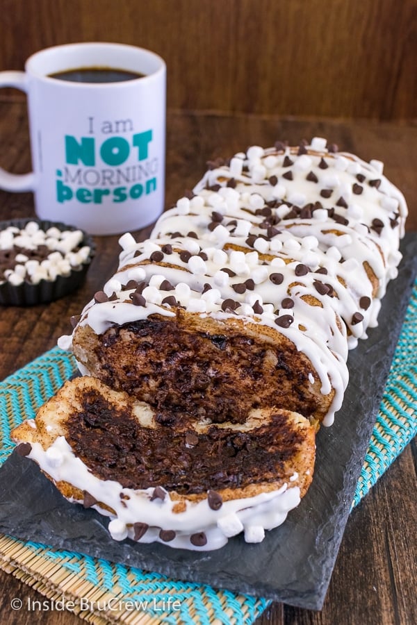 A loaf of gooey s'mores pull apart bread topped with a marshmallow glaze and mini marshmallows