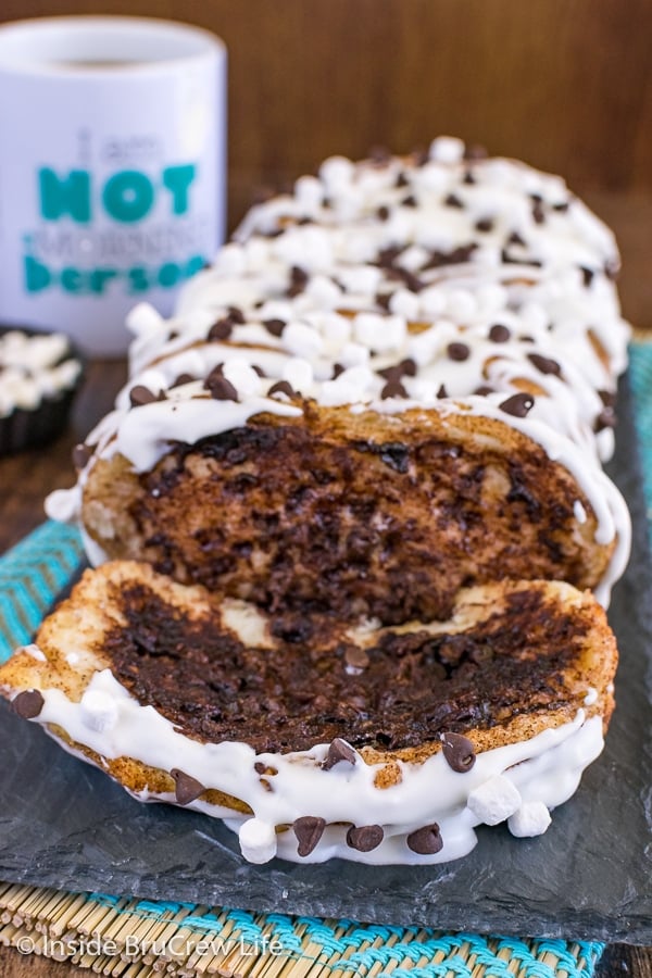 a close up picture of a loaf of gooey s'mores pull apart bread with a slice lying down in front