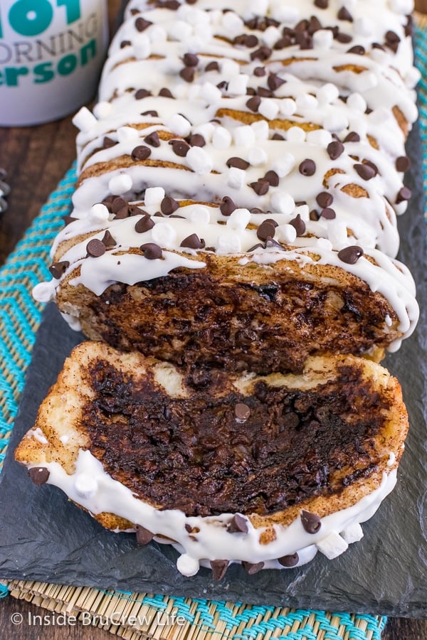 A close up picture of a slice of gooey s'mores pull apart bread with lots of gooey chocolate