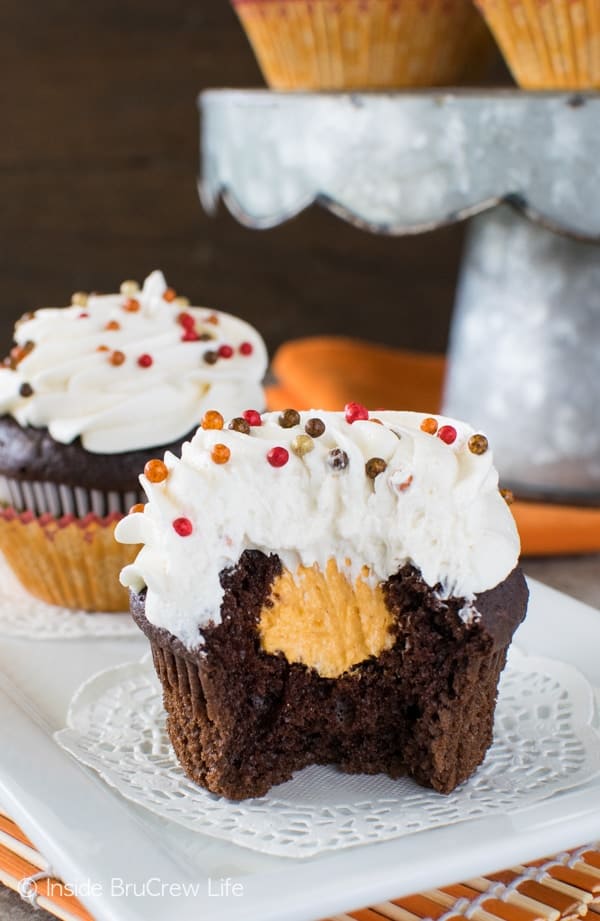 Chocolate Pumpkin Cream Filled Cupcakes - the hidden pumpkin cream center adds a fun flair to these cupcakes. Great recipe for fall parties!