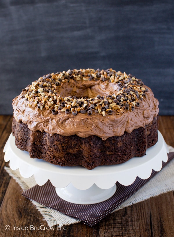 A creamy frosting and pecan chips are an easy way to decorate this Chocolate Pumpkin Cheesecake Bundt Cake. Great dessert recipe for fall parties! 