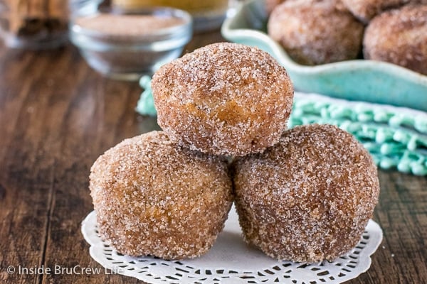 Three cinnamon sugar apple donut holes stacked on top of each other.