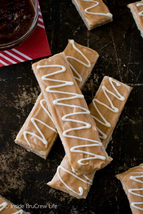 A sheet pan with apple butter bars stacked on it