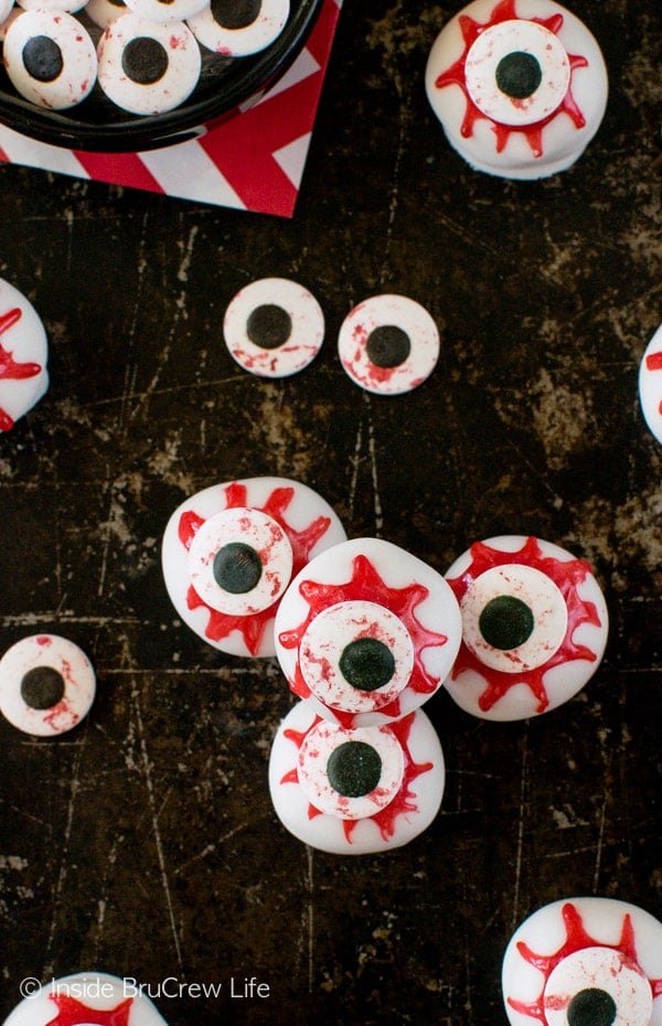 An overhead picture of a black tray with peanut butter zombie eyeballs all over it.