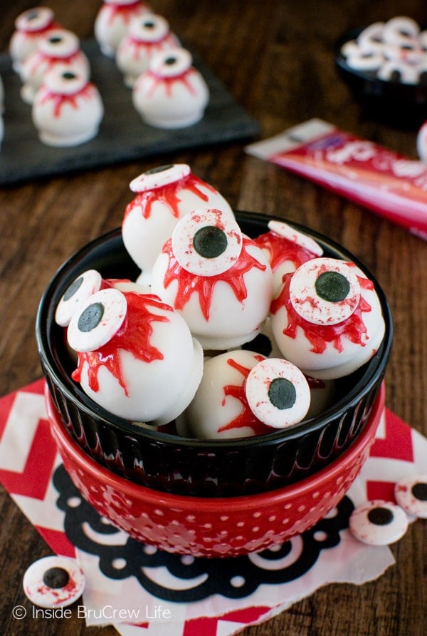 Black and red bowls stacked together and filled with peanut butter zombie eyeballs