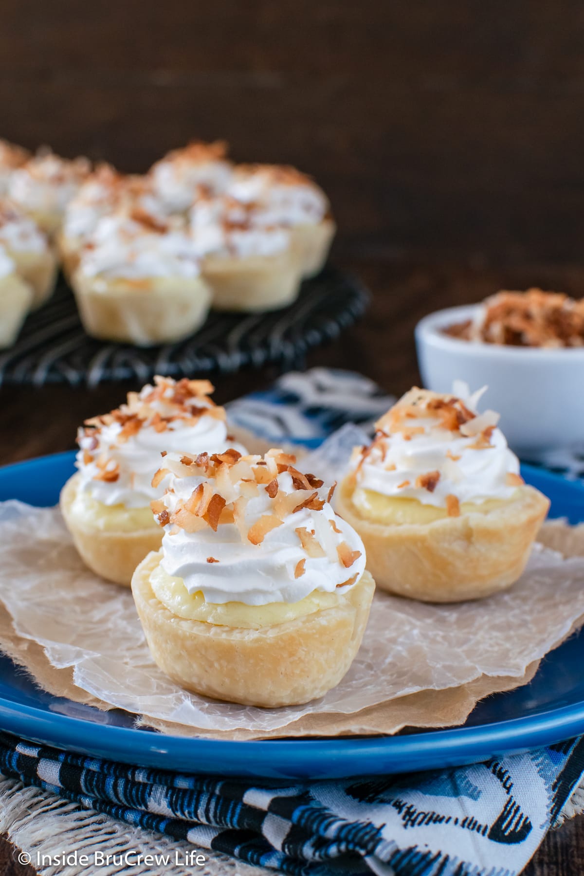A blue plate with three mini cream cheese pie bites on it.