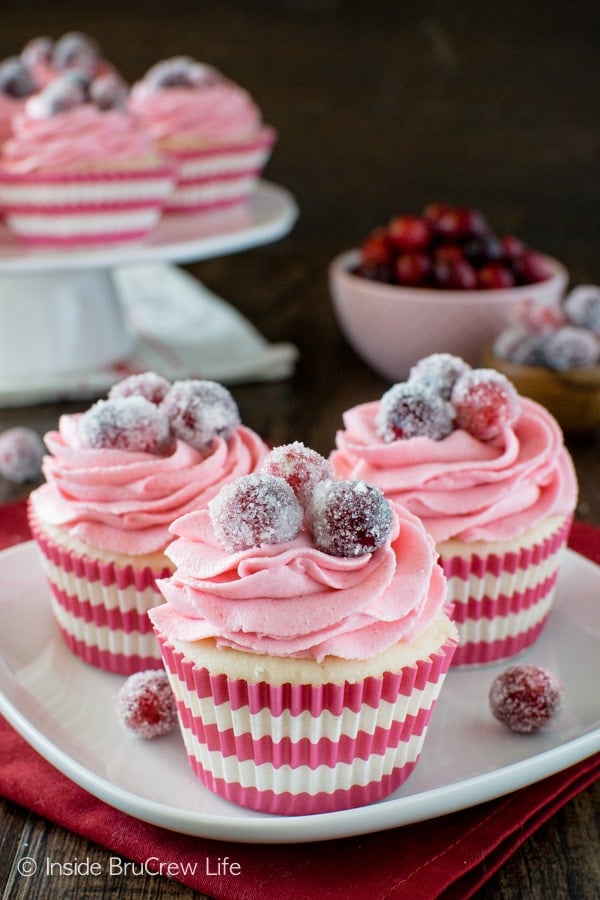 Fresh berry frosting & a white chocolate center give these homemade Sparkling Cranberry White Chocolate Cupcakes a beautiful look. Great recipe for the holidays!