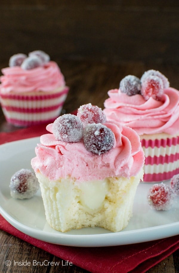 Sparkling Cranberry White Chocolate Cupcakes - a hidden chocolate center & fresh berry frosting makes these easy homemade cupcakes a delicious holiday recipe!