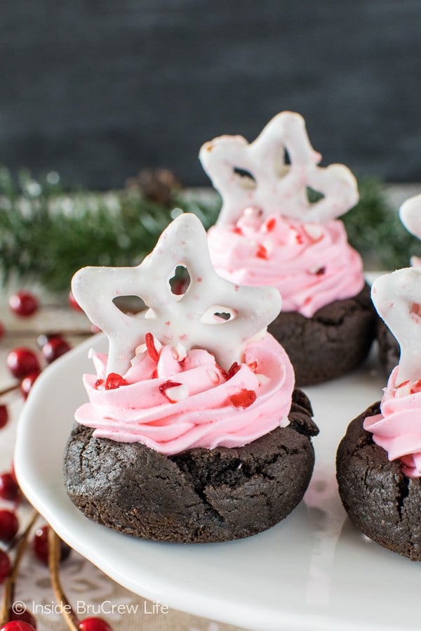 A creamy pink filling and candy cane bits add a fun holiday twist to these Chocolate Peppermint Fluff Cookie Cups. Great dessert recipe for holiday parties!