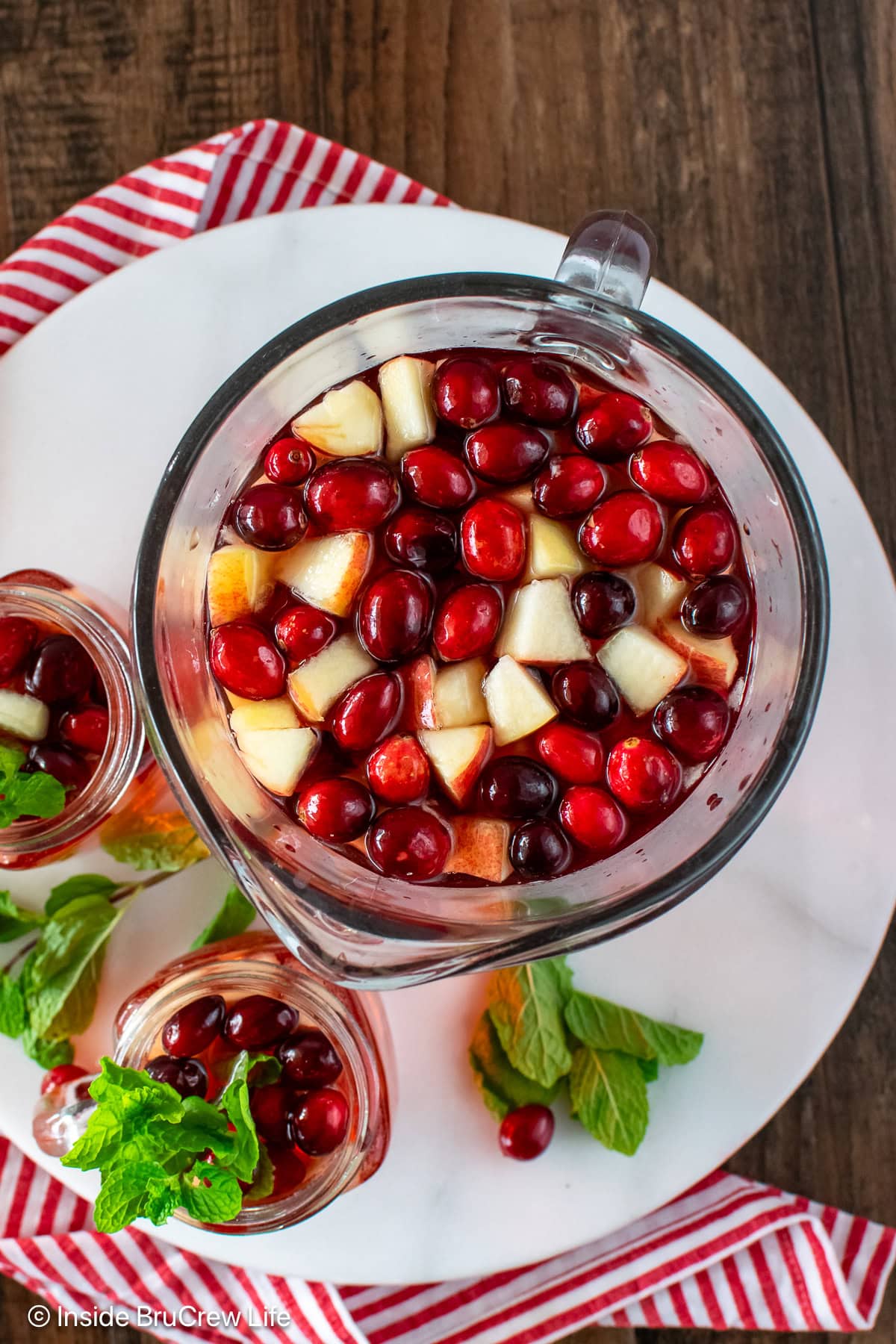 Fresh fruit floating in a pitcher of party punch.