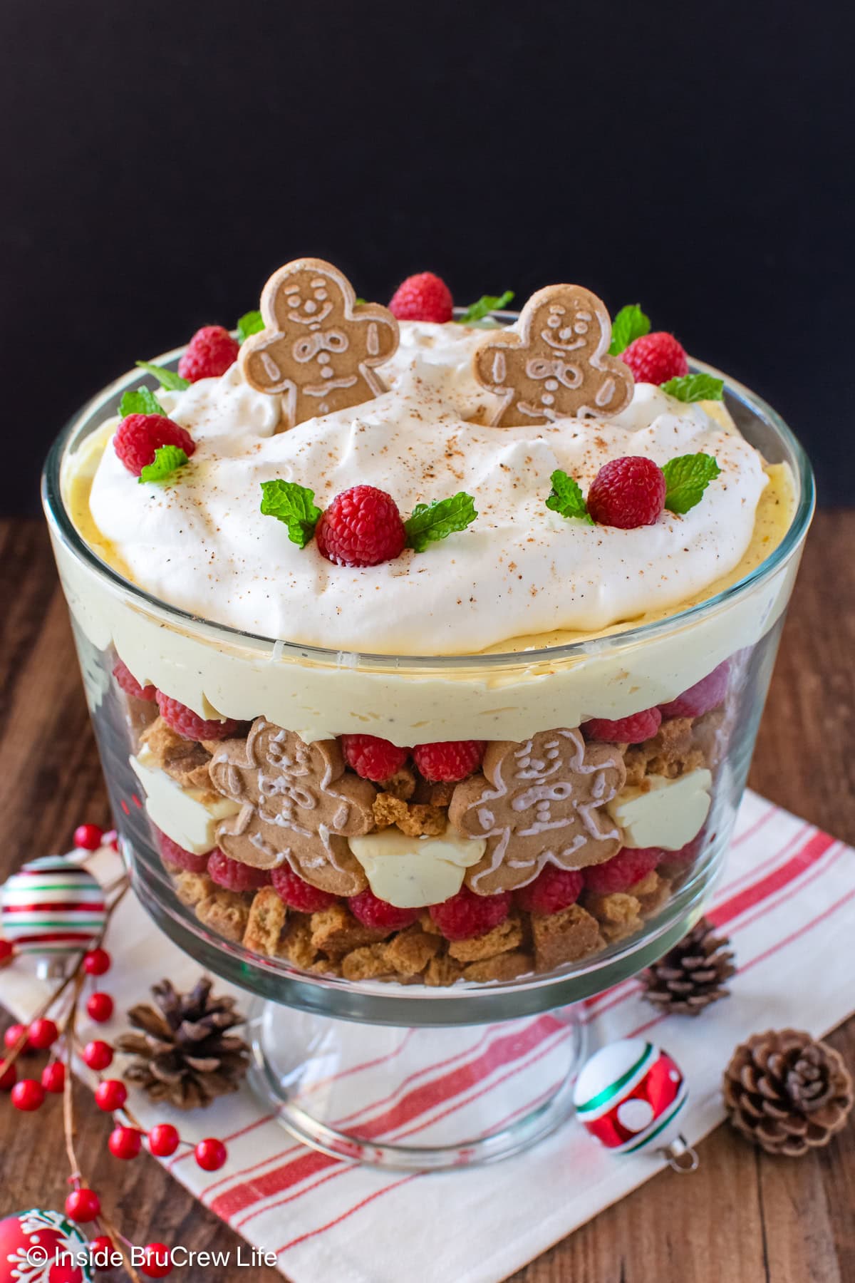 A clear glass bowl filled with an eggnog trifle.