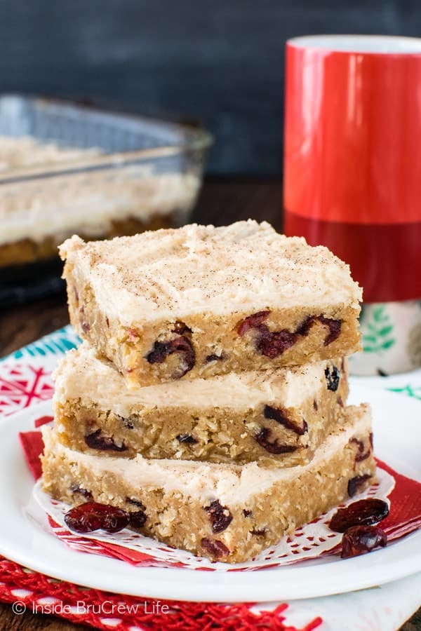 A white plate with a stack of apple butter cranberry bars stacked on it