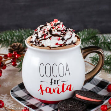 A mug of hot cocoa topped with whipped cream.