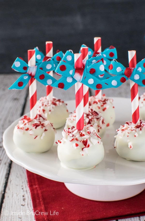 Straws & ribbons make these easy Peppermint Brownie Truffles stand out on the cookie trays. Great recipe for holiday parties!